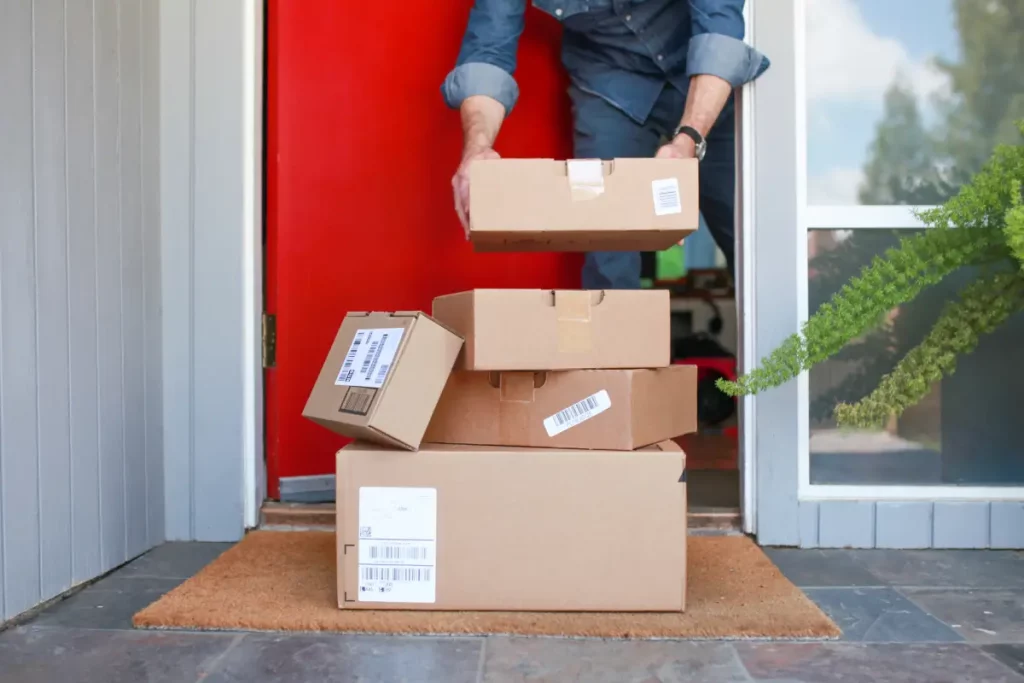 man picking up delivered packages from the porch 2022 10 31 22 08 43 utc